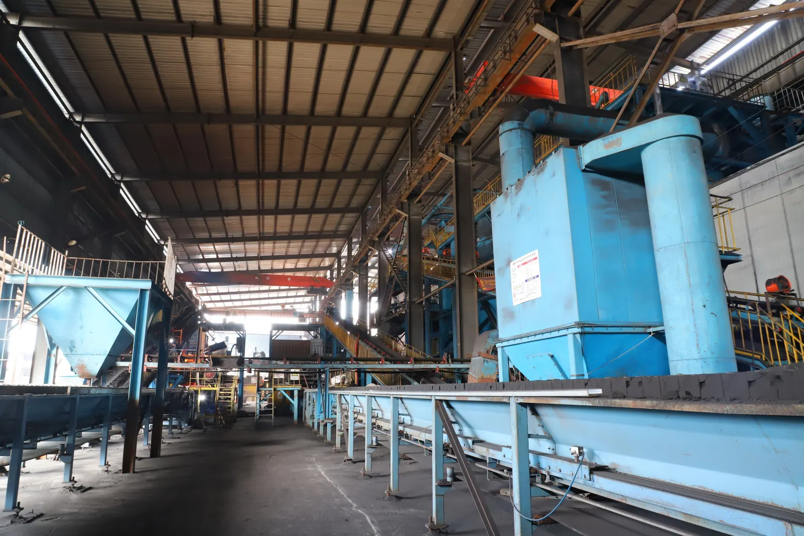 Interior view of a cast iron foundry line with industrial equipment and workshop aisle