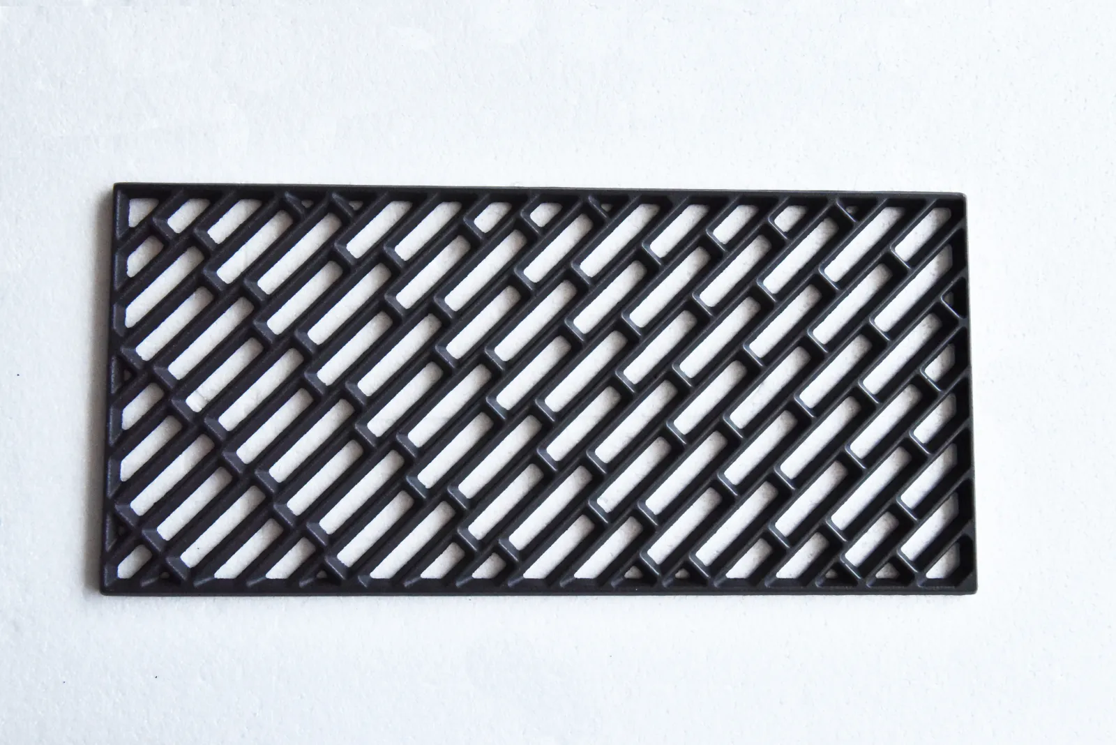 Rectangular cast iron grill grate with an angled lattice pattern
