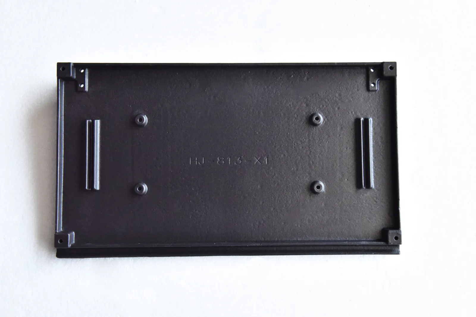 Rectangular custom cast iron component with mounting openings